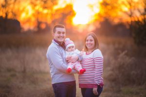 Family with sunset behind.